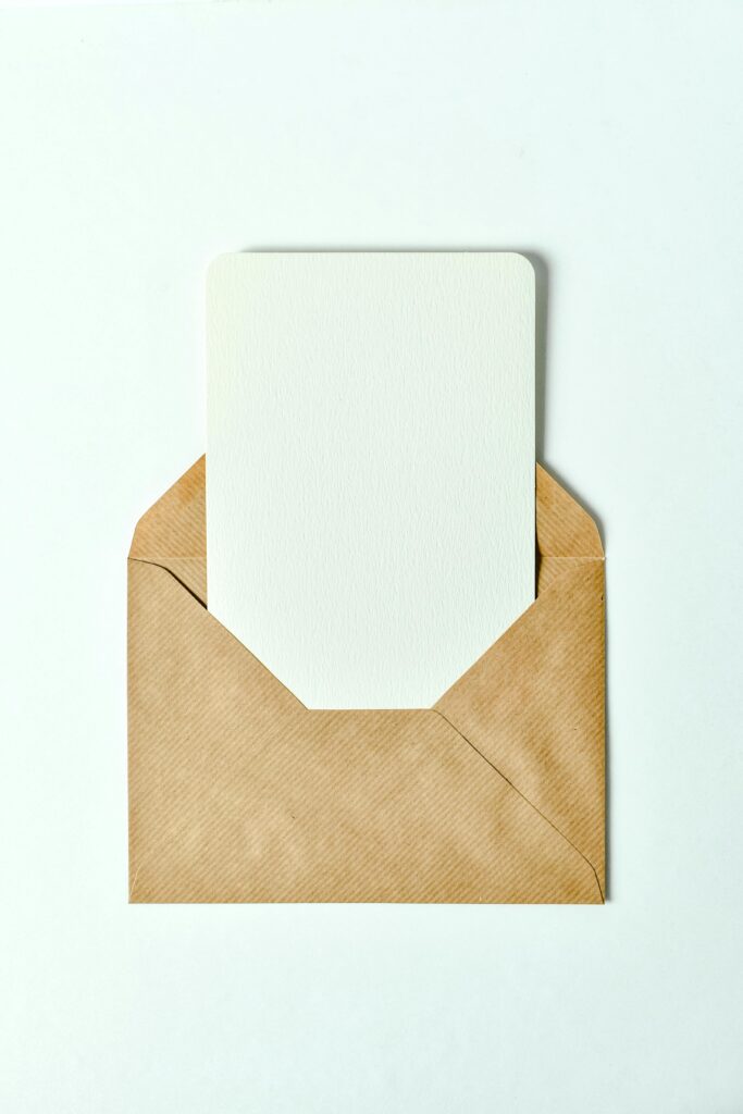 Minimalist brown envelope showcasing a blank card insert - perfect for invitations or greetings.